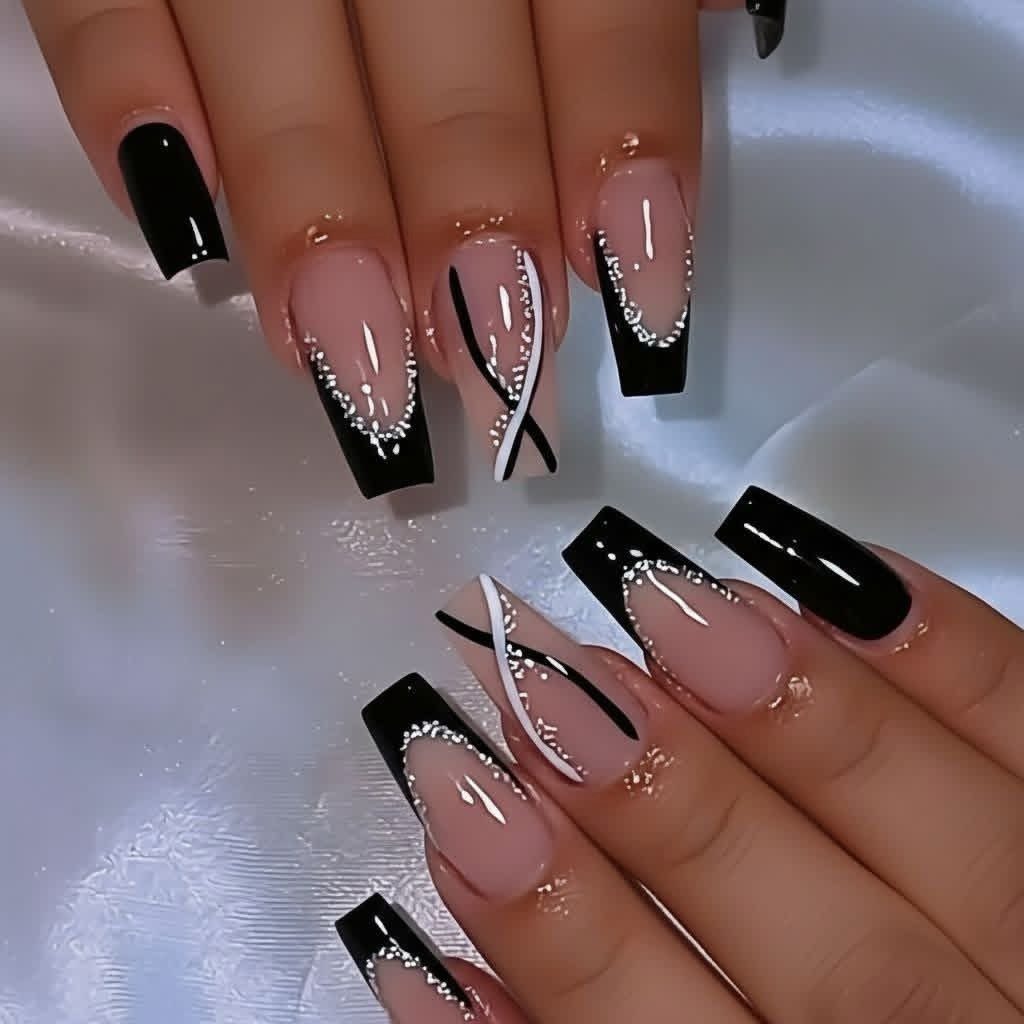Long coffin-shaped manicured nails with black tips and silver rhinestones on a white background.