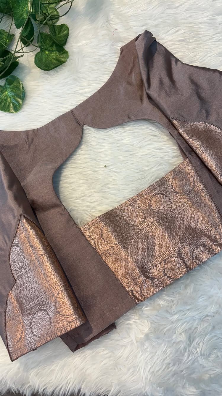 A brown sleeveless blouse with metallic copper Banarasi fabric panels and a large keyhole back cutout.