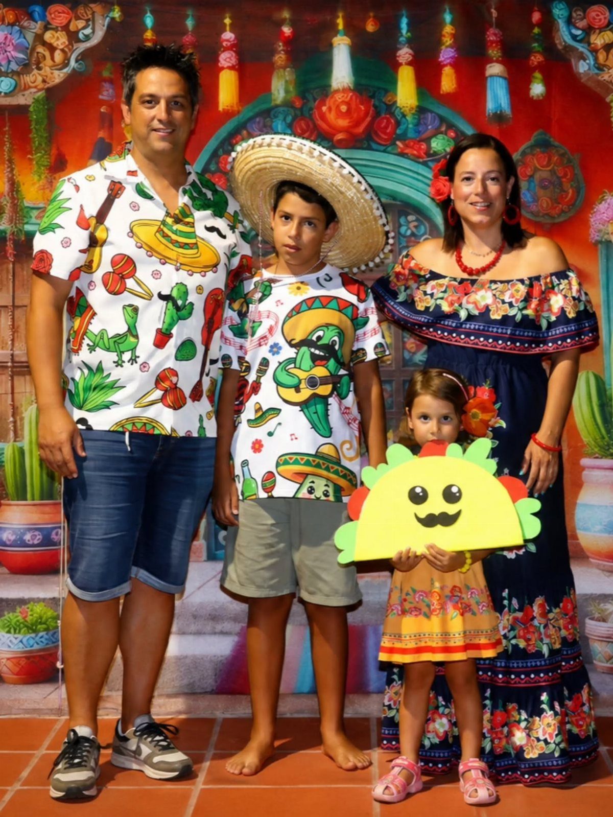 A family posing in colorful Mexican-themed clothing against a vibrant, decorated background.