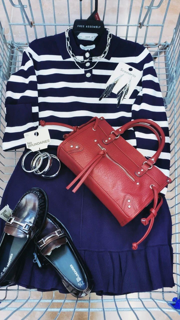 Navy and white striped shirt with a red handbag and loafers in a shopping cart.