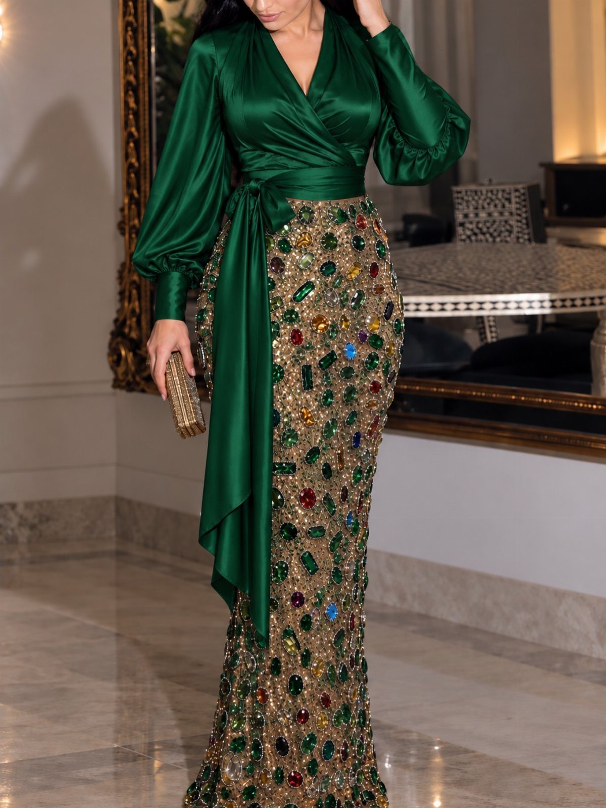 Woman wearing a green satin dress with a heavily embellished gemstone skirt.