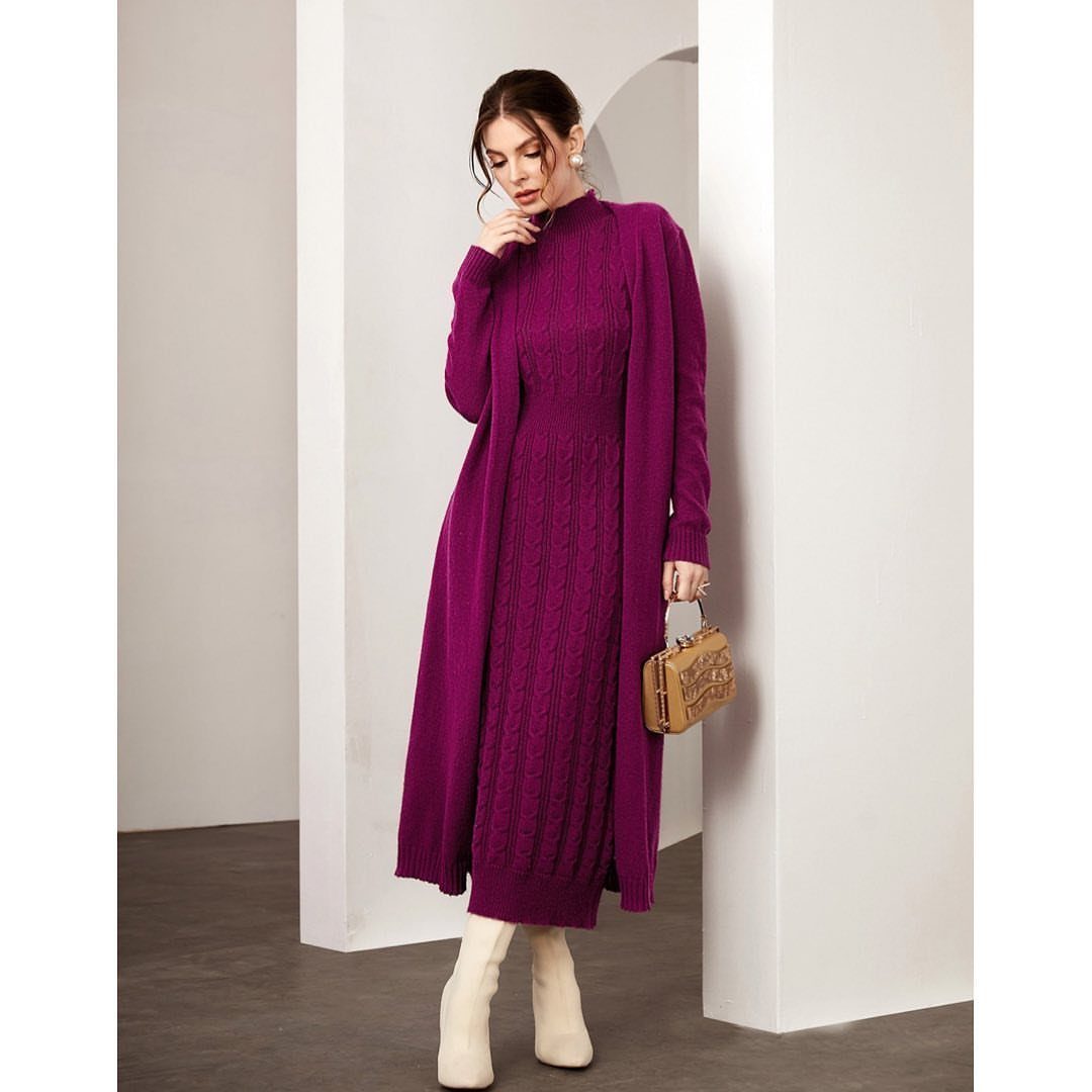 Woman in a magenta cable-knit sweater dress and matching long cardigan with cream boots.
