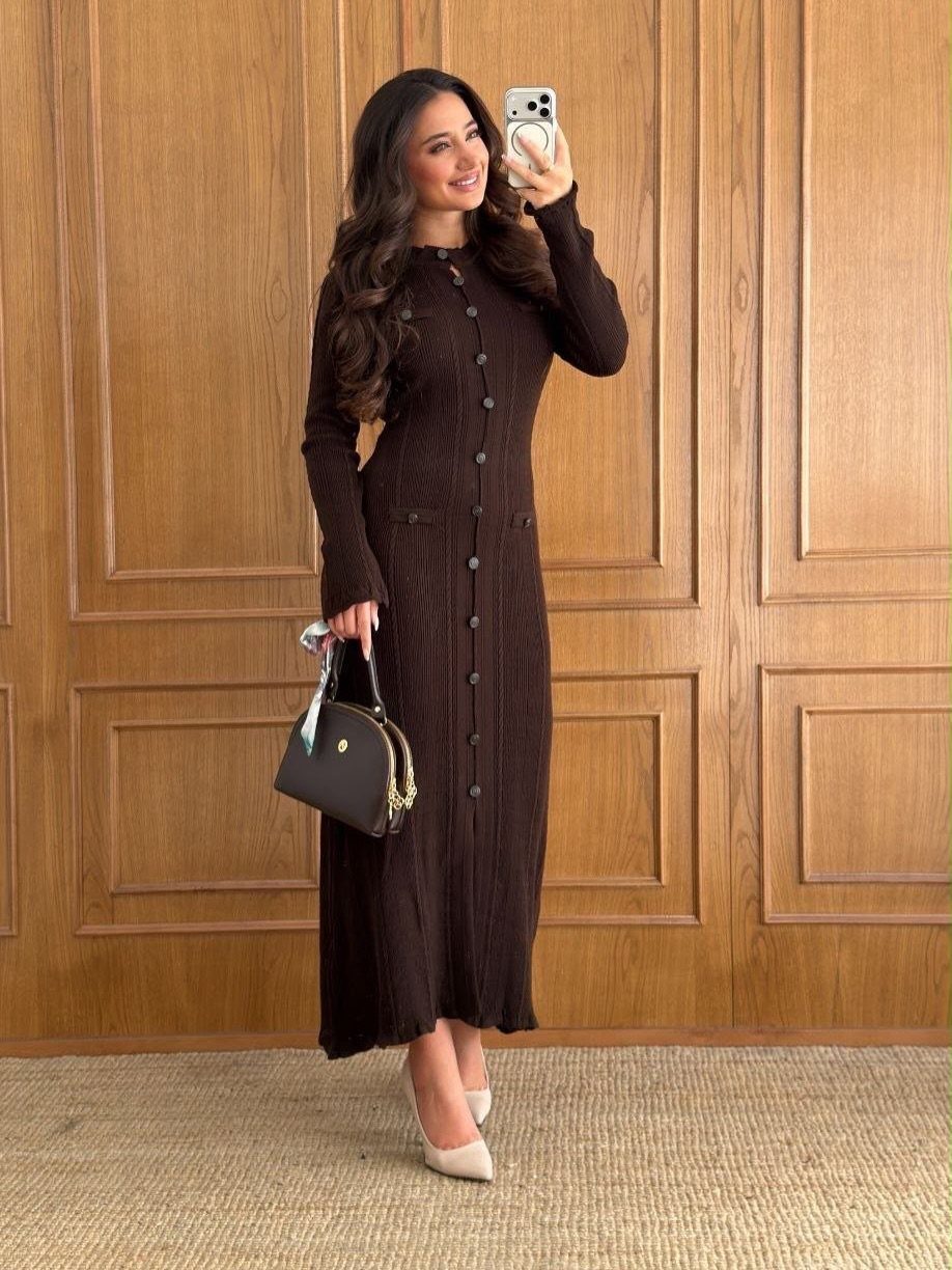 Woman in a long-sleeved dark brown ribbed knit maxi dress posing for a mirror selfie.