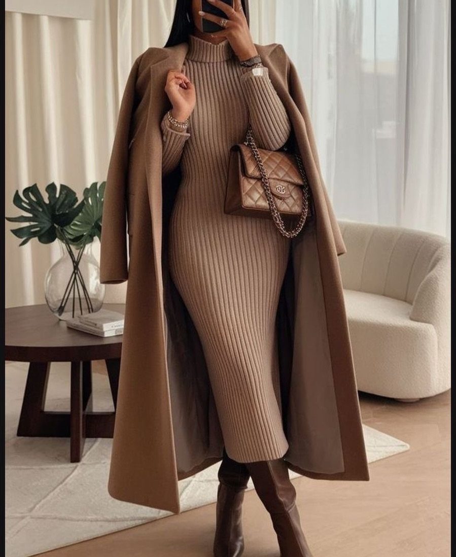 Person wearing a tan ribbed knit maxi dress with a long camel coat and brown boots.
