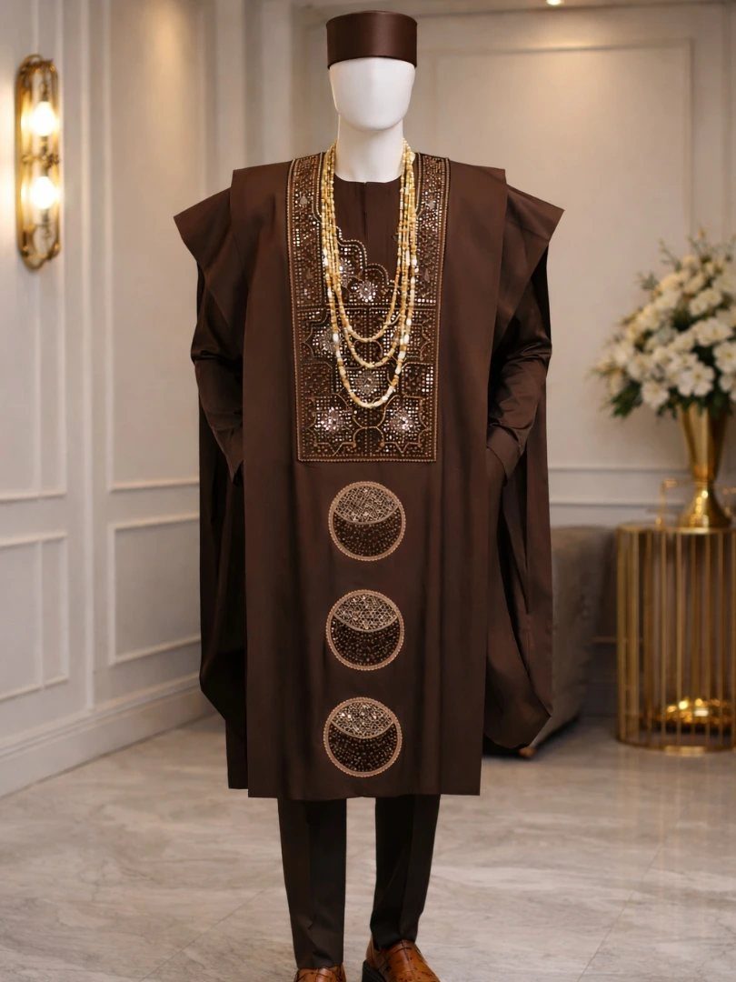 A brown Agbada outfit with gold embroidery displayed on a white mannequin.