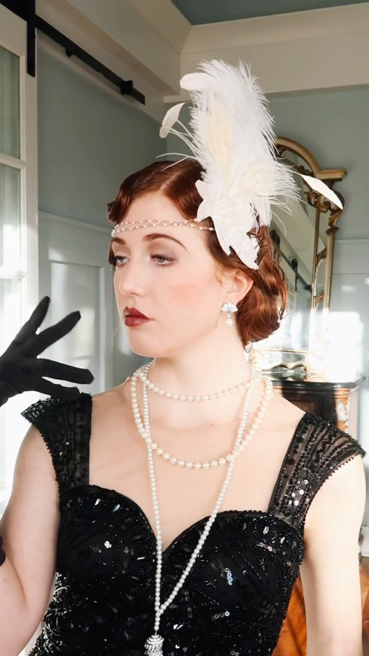 Woman with red hair styled in finger waves wearing vintage 1920s flapper attire.