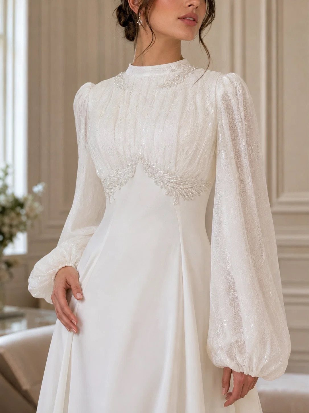 Woman in a white wedding dress featuring voluminous, long bishop sleeves gathered at the wrists.